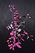 Tree-shaped arrangement of twigs and nuts painted pink and silver