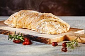 Ciabatta bread on an olive wood board