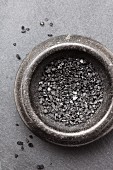 A bowl of black vulcan salt (seen from above)