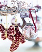 Artistically embroidered decorations and glass bauble hung from metal wreath