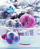 Ornate Christmas baubles in glass dish