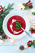 Beetroot soup in a bowl with Christmas decorations