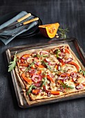 Tarte flambée with pumpkin, apple and red onions
