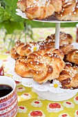 Almond pastries with sugar nibs on a cake stand