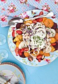 Warm salad with beetroot, sweet potatoes, cherry tomatoes and beans with yoghurt dressing