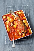 Oven-baked cod with potatoes, chorizo and tomato sauce