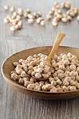 Chickpeas in a wooden bowl with a spoon