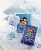 Presents wrapped in blue paper decorated with scrapbook angels and French wire