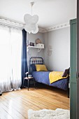 Vintage-style child's bedroom with stucco frieze and wooden floor