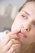 Woman applying lip balm