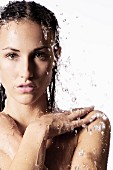 Topless woman under running shower