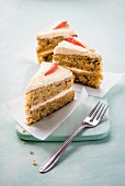 Three slices of carrot cake with a fork