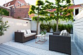 Lounge furniture in seating area of modern courtyard garden