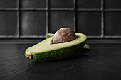 A halved avocado with a stone