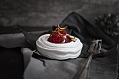 A raspberry meringue nest with sweet meal worms