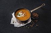 Pumpkin soup with cream cheese and crispy meal worms