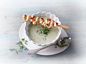 Broccoli soup with a chicken skewer