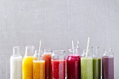 Various smoothies in glass bottles