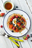 A vegan, gluten-free waffle with fresh berries and yoghurt