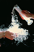 Dry ice being poured into cupped hands