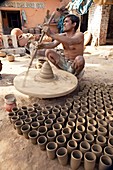 Throwing pots,India