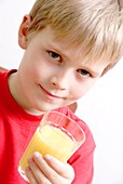 Boy holding a glass of orange juice