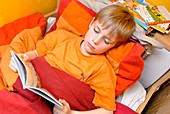 Boy reading in bed
