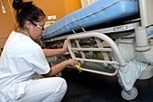 Nurse cleaning hospital bed