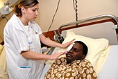 Nurse changing a facial dressing