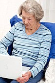 Elderly lady using a laptop