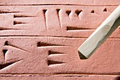 Cuneiform clay tablet and stylus