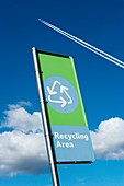 Recycling sign with jet contrail