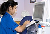 Nurse sets a dialysis machine