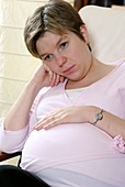 Pregnant woman looking bored
