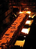 Molten steel bars being cut