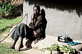 Man sitting outside a hut,Uganda