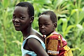 Girl carrying a young child,Uganda