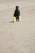 Young child carrying water,Uganda