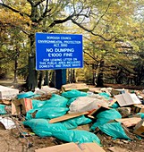 Dumped rubbish next to flytipping sign