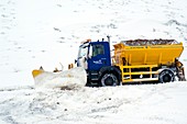 A Snow plough clearing a road