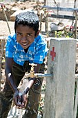 Boy playing with water,Timor-Leste