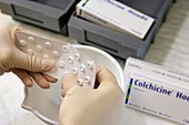 Pharmacist dispensing colchicine tablets