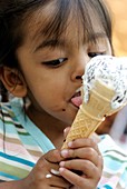 Young girl eating an ice cream