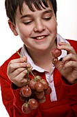 Boy eating grapes
