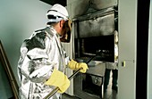 Crematorium worker removing ashes