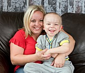 Boy with prosthetic eye,with mother