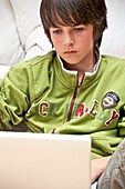 Teenager using a laptop computer