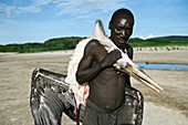Hunter with stork,Tanzania