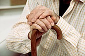 Elderly man holding a walking stick