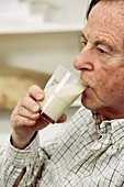 Elderly man drinking milk